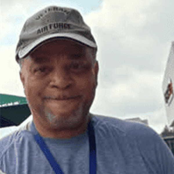 Man wearing Air Force cap outdoors.
